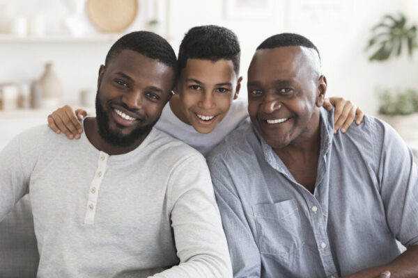 Happy black son, father and grandfather posing for family picture together Happy black son, father and grandfather posing for family picture together